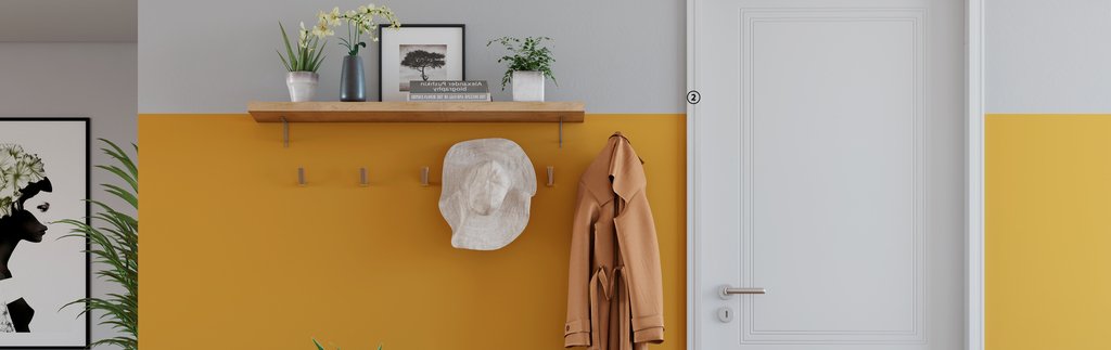 Door knocker in yellow decorated wall.