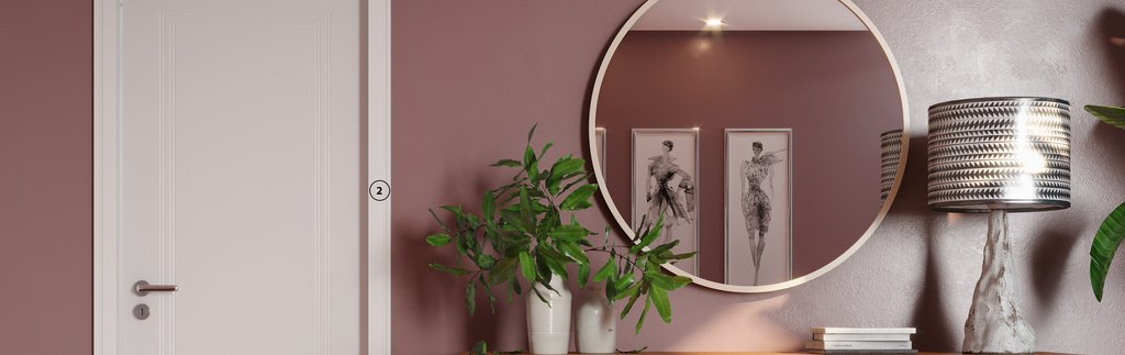 Imagem mostra sala de entrada com parede rose, porta branca e aparador com plantas. 