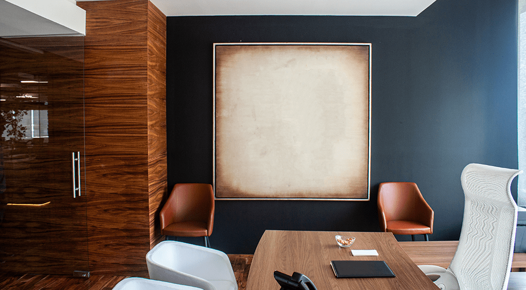 A wooden cladding with a glass door is an elegant combination for the board room.